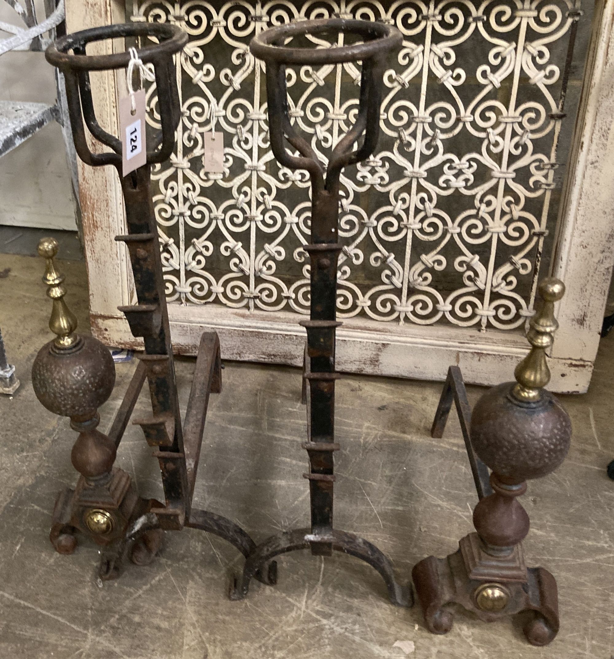 A pair of Victorian wrought iron fire dogs, together with one other pair of brass mounted fire dogs, largest 73cm high